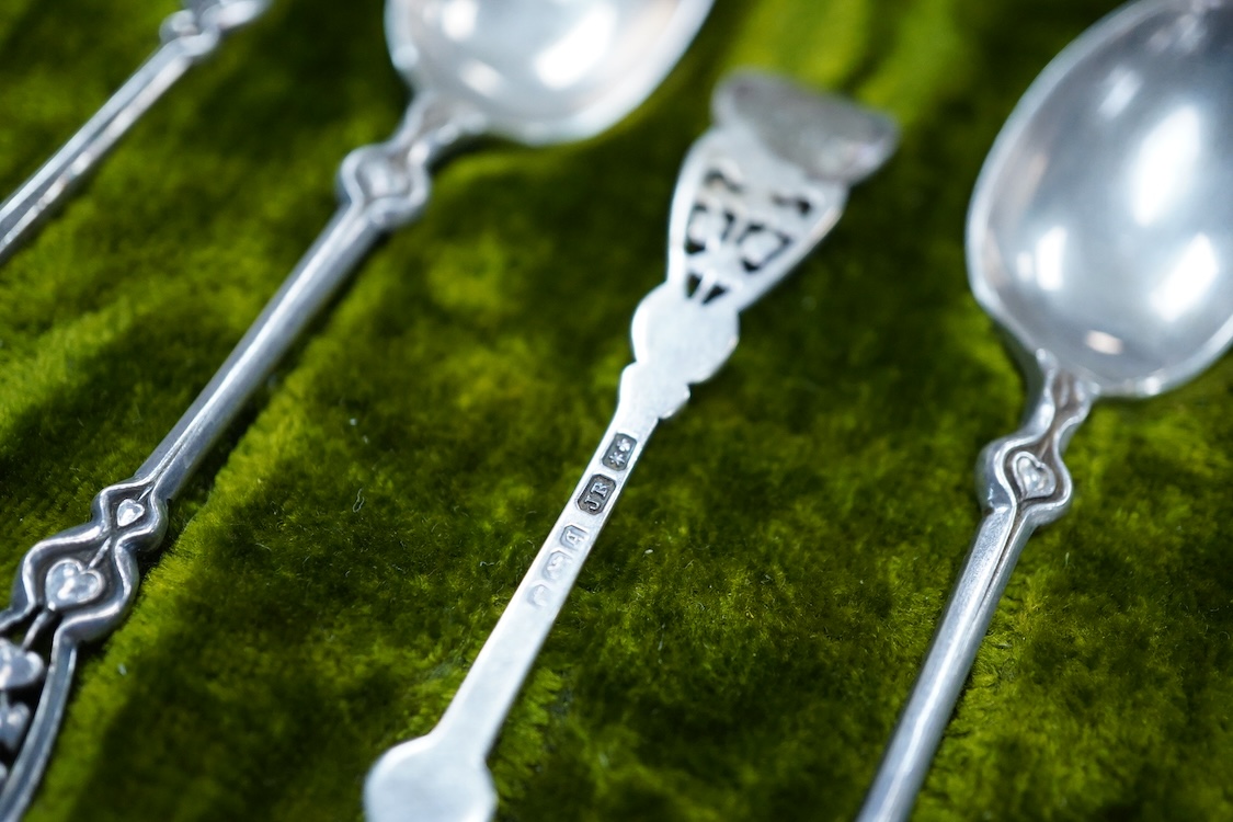 A cased set of six Edwardian Art Nouveau silver coffee spoons, Joseph Rodgers & Sons, Sheffield, 1908, 10.9cm, with pierced stylised terminals.